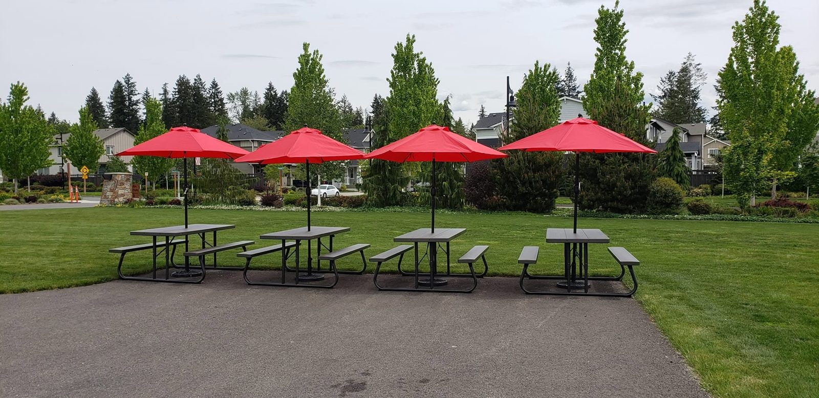 Picnic tables with red umbrellas at The Commons